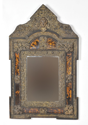 19th-century beveled Italian mirror with tortoise cushion and a decorative pressed brass surround. Image courtesy of Morton Kuehnert Auctioneers & Appraisers.